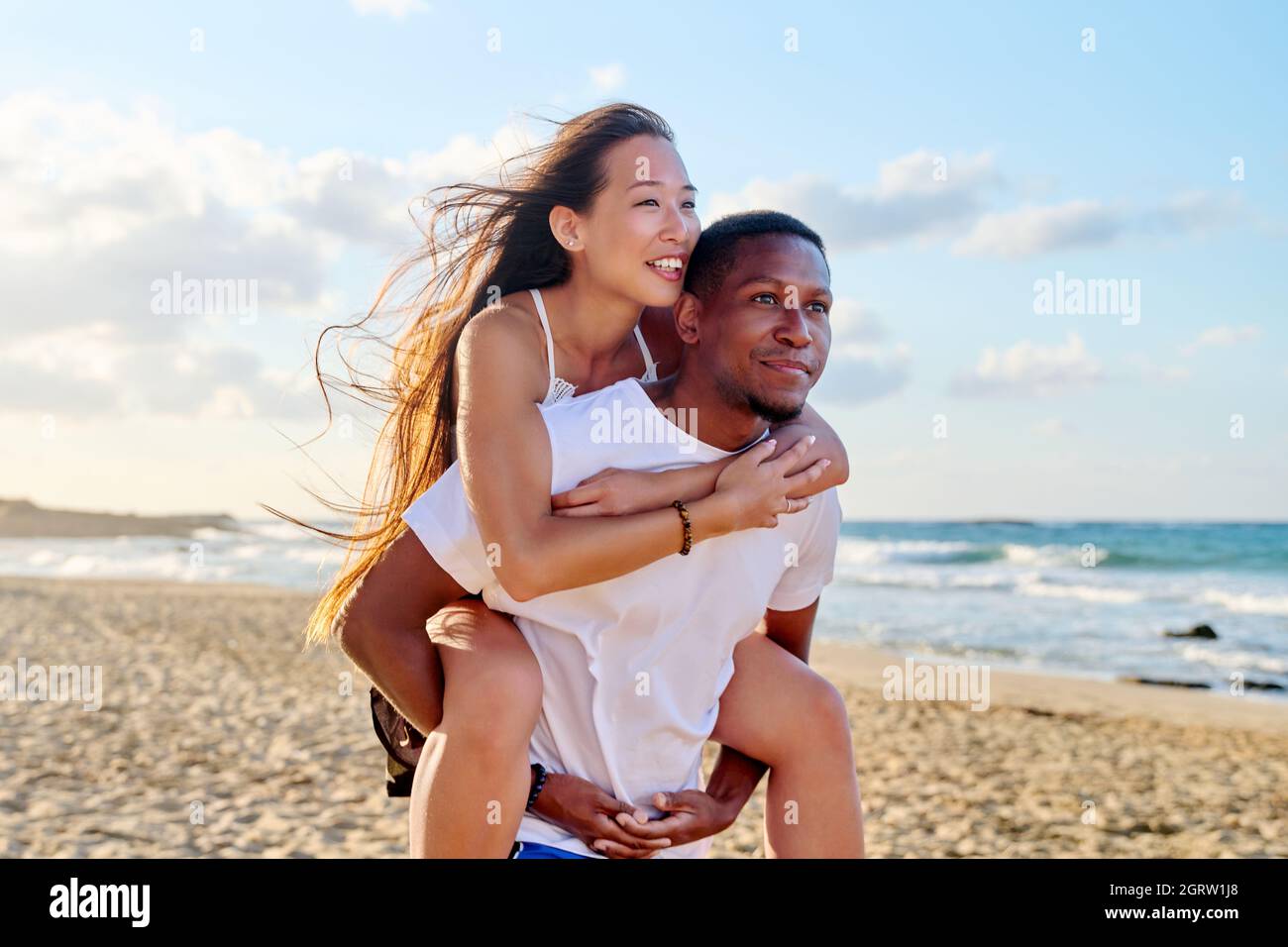 Young beautiful having fun couple on the sea background Stock Photo