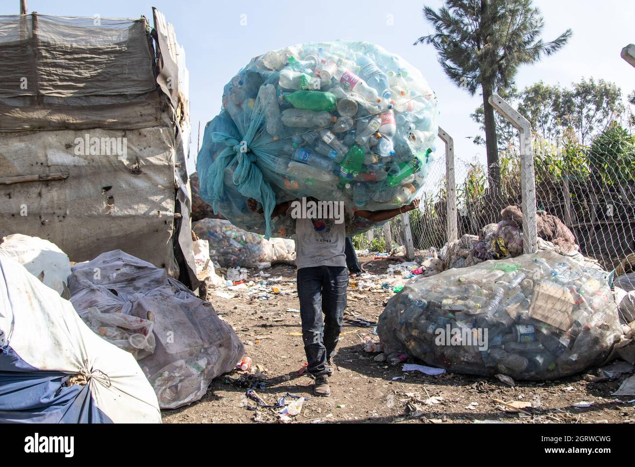 Nakuru, Kenya. 01st Oct, 2021. A man carries a heavy load of plastic