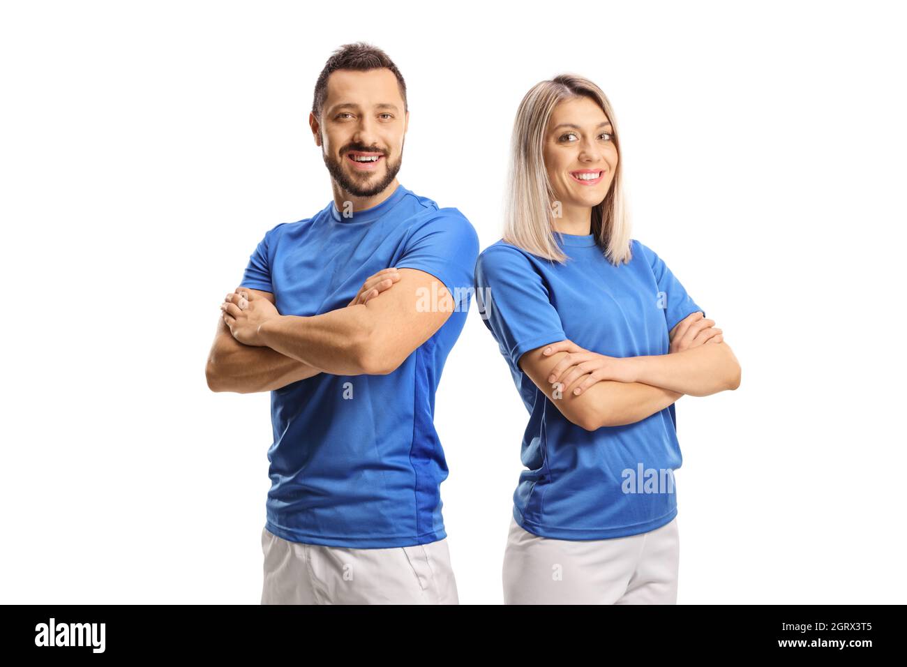 Portrait of a young male and female wearing blue sport jersey and posing with crossed hands isolated on white background Stock Photo