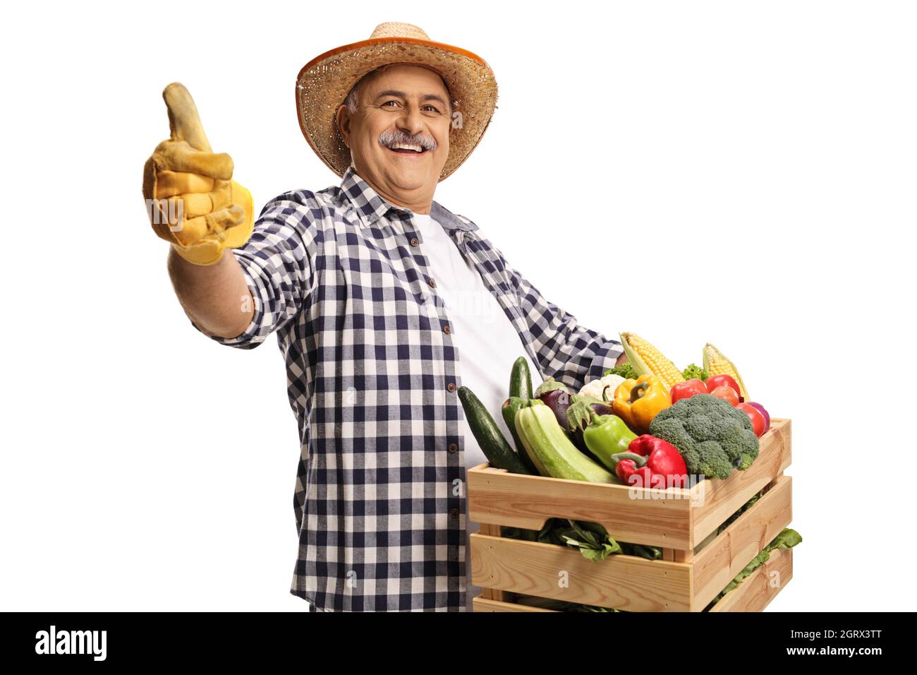 Cheerful mature farmer holding a crate with fresh organic vegetables ...