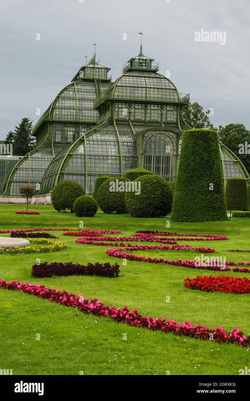 31 May 2019 Vienna, Austria - Palmenhaus building at Schonbrunn gardens. (Palm house) Constructed of iron and glass. Tidy lawns and cloudy day Stock Photo