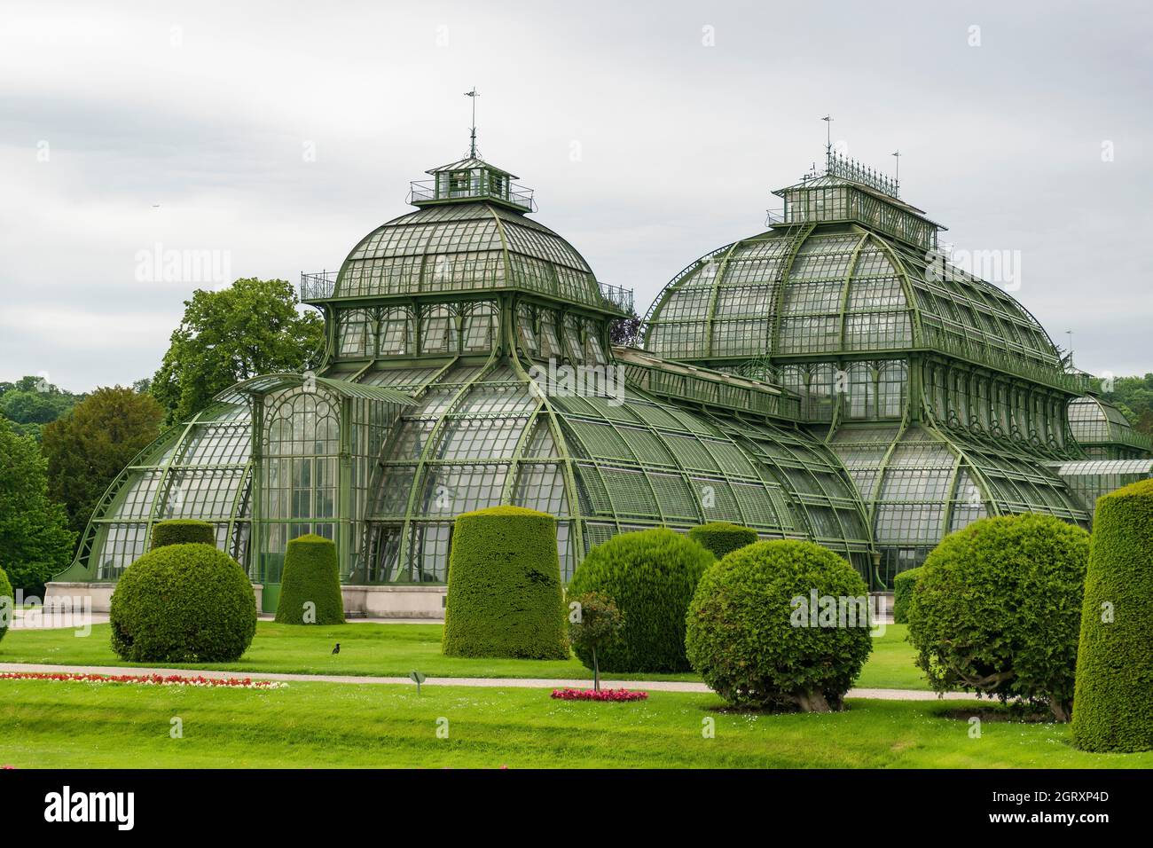 31 May 2019 Vienna, Austria - Palmenhaus building at Schonbrunn gardens. (Palm house) Constructed of iron and glass. Tidy lawns and cloudy day Stock Photo