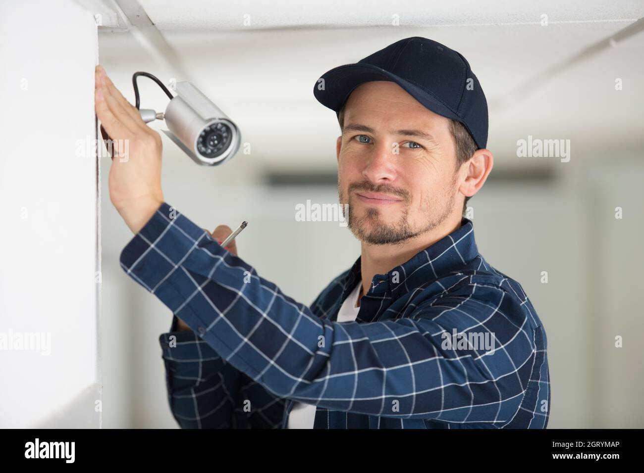 worker is ready to install the cctv camera Stock Photo Alamy