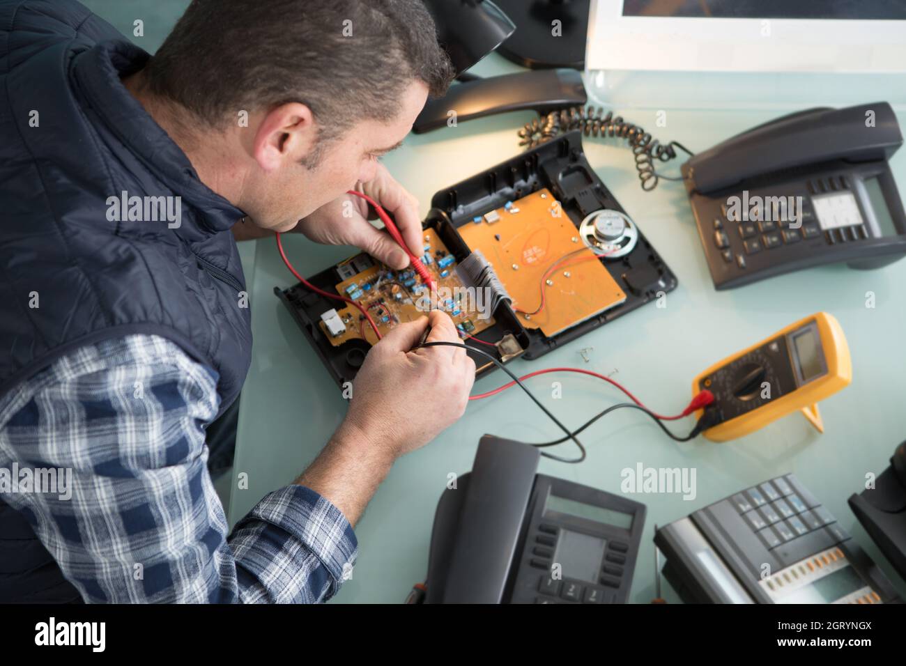 engineer using multimeter to test a telephone Stock Photo Alamy