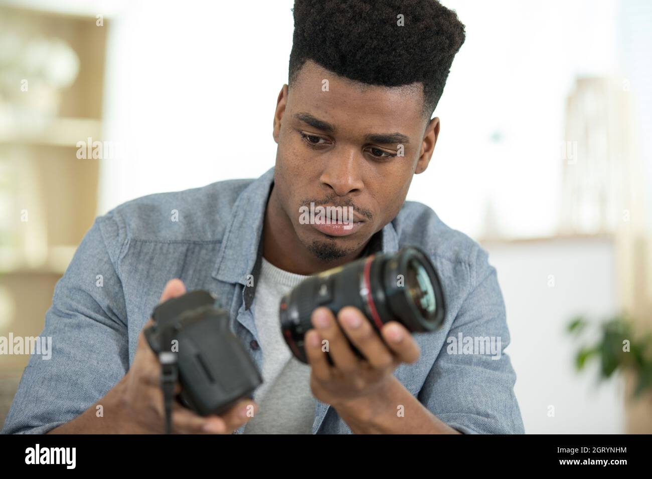 young people change the lens on the camera Stock Photo Alamy