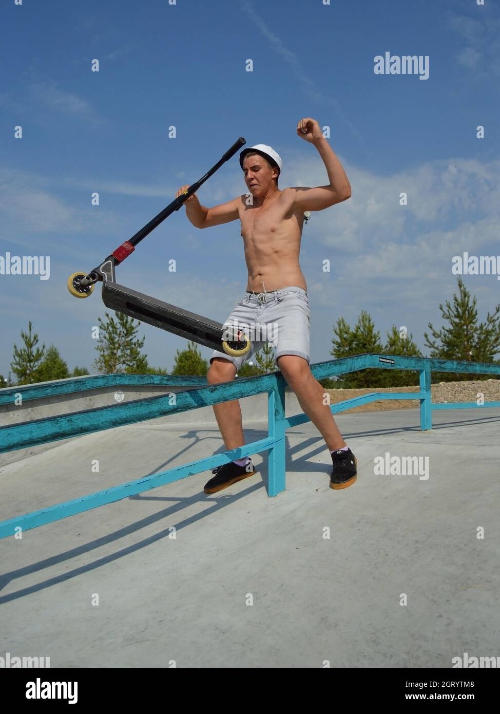 Dobrograd, Vladimir region, Russia. 29 July 2017. Teen on scooter failed performs a trick in the skatepark Stock Photo