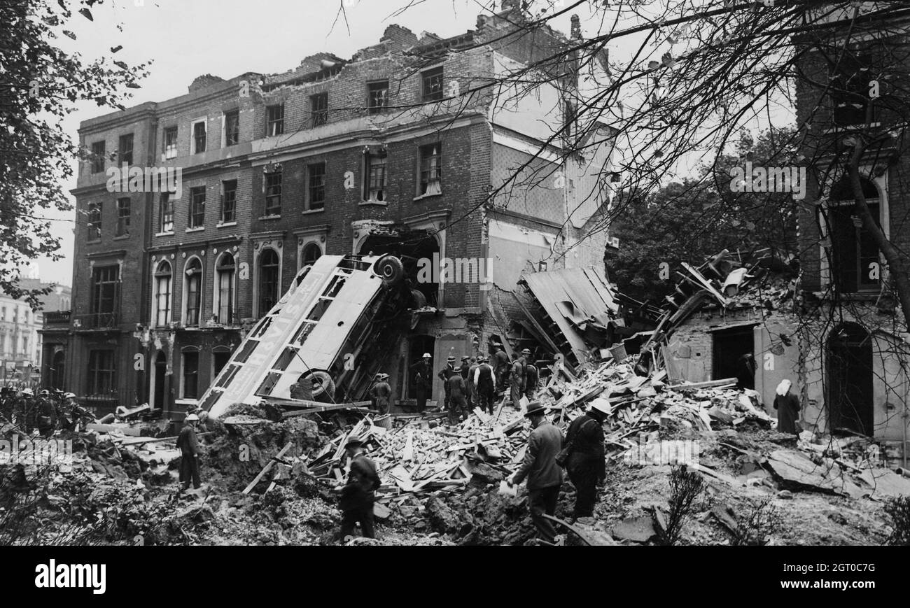 A bus is left leaning against the side of a building in Harrington Square, Mornington Crescent,after an air raid on London in the first days of the Blitz, 9th September 1940. Stock Photo