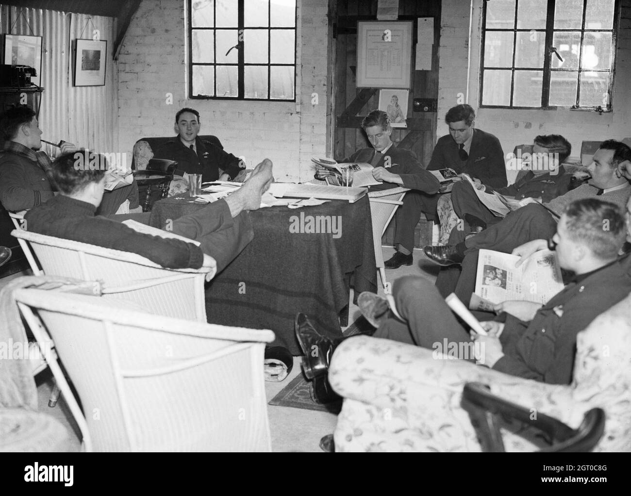 Squadron Leader B J E 'Sandy' Lane, the Commanding Officer of No. 19 Squadron RAF (facing camera), relaxes with some of his pilots in the Squadron crew room at Manor Farm, Fowlmere, Cambridgeshire,September 1940. Stock Photo