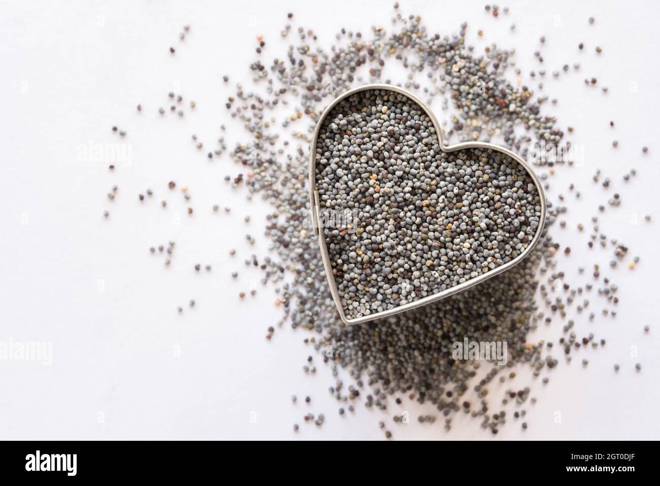 Poppy Seeds In A Heart Shape Stock Photo