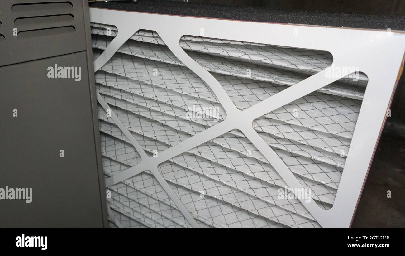 Installing a clean air filter in a furnace Stock Photo Alamy