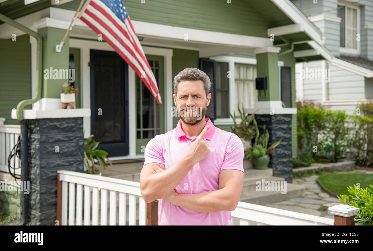 real estate agent point finger on house for sale. realtor welcoming visitors. rent or buy new home Stock Photo