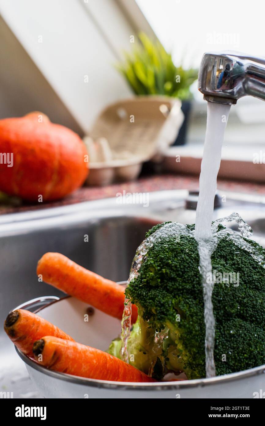 Close-up Of Veggies Being Washed Stock Photo