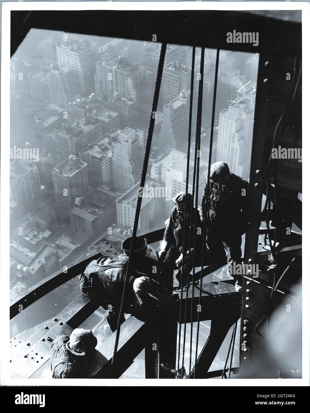EMPIRE STATE BUILDING NY,NY 1930 - 1931. General and detailed views of the Empire State Building under construction showing workers performing various tasks including positioning, welding and riveting steel, hoisting materials and supplies, and operating and repairing machinery. There are also birds-eye views of midtown Manhattan showing other buildings under construction. Photographs by: Hine, Lewis Wickes, 1874-1940 . Stock Photo