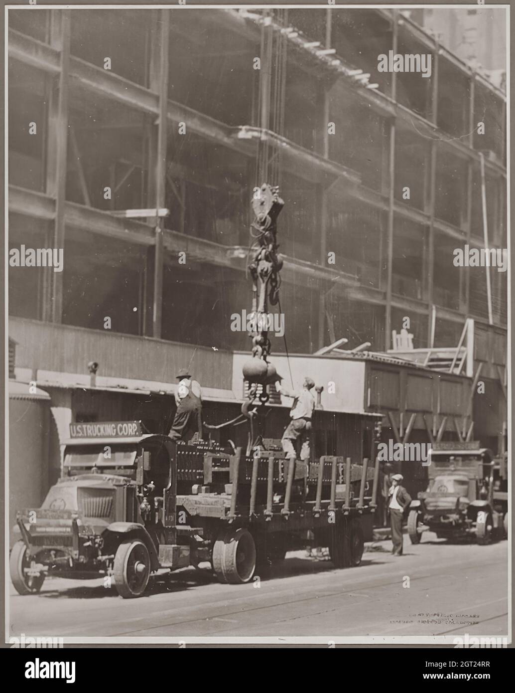 EMPIRE STATE BUILDING NY,NY 1930 - 1931. General and detailed views of the Empire State Building under construction showing workers performing various tasks including positioning, welding and riveting steel, hoisting materials and supplies, and operating and repairing machinery. There are also birds-eye views of midtown Manhattan showing other buildings under construction. Photographs by: Hine, Lewis Wickes, 1874-1940 . Stock Photo