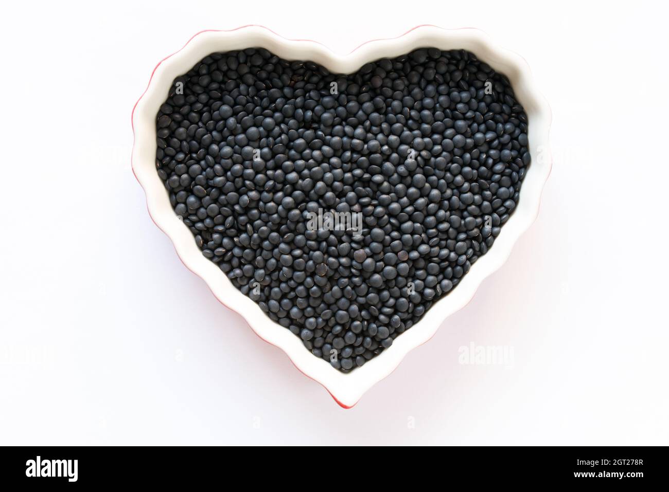 Uncooked Black Lentils In A Bowl Stock Photo