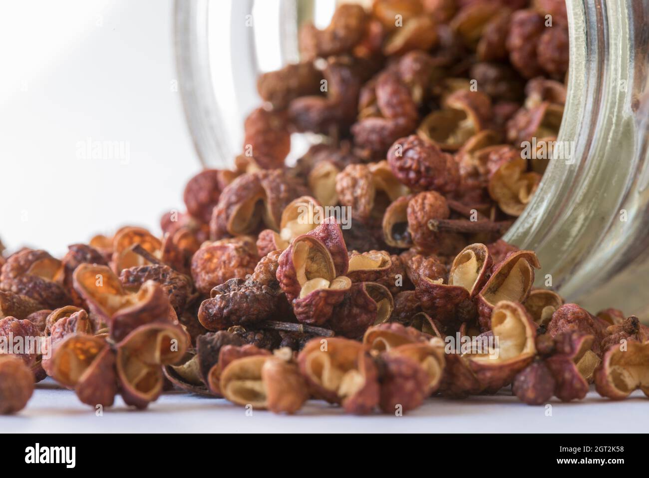 Szechuan Peppercorns Spilled From A Spice Jar Stock Photo