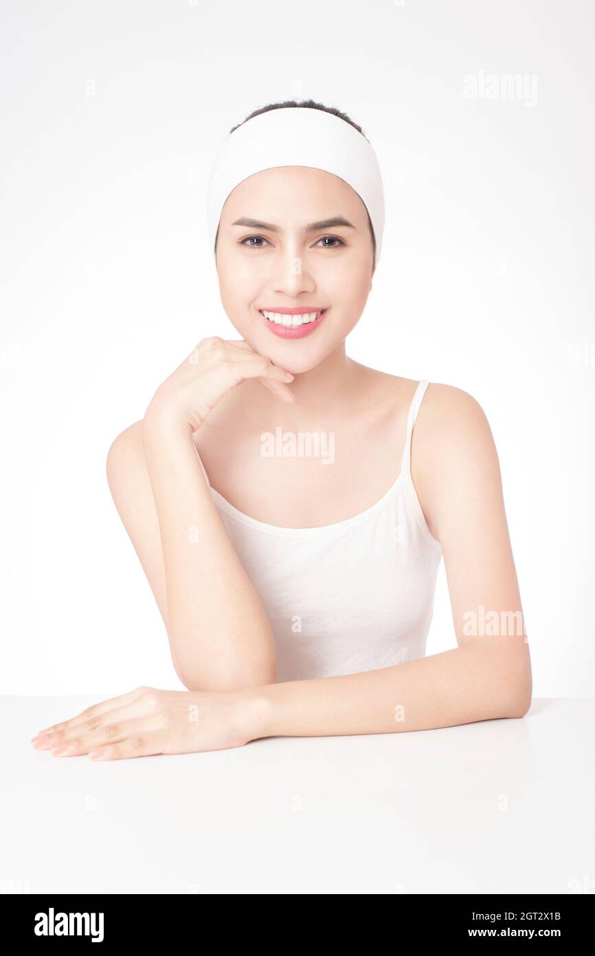 Portrait Of Smiling Young Woman Over White Background Stock Photo