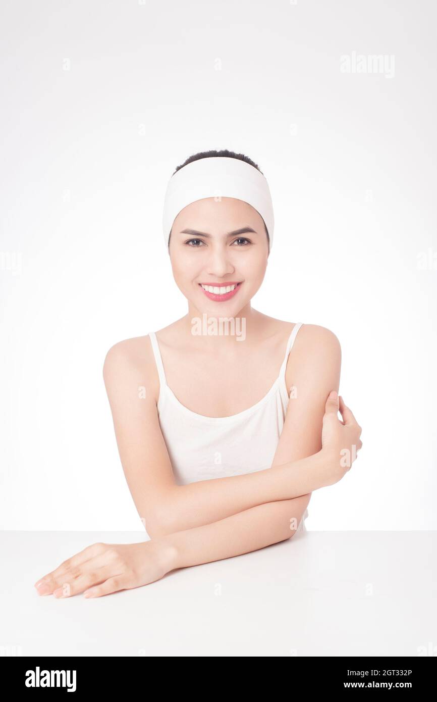 Portrait Of Smiling Young Woman Over White Background Stock Photo