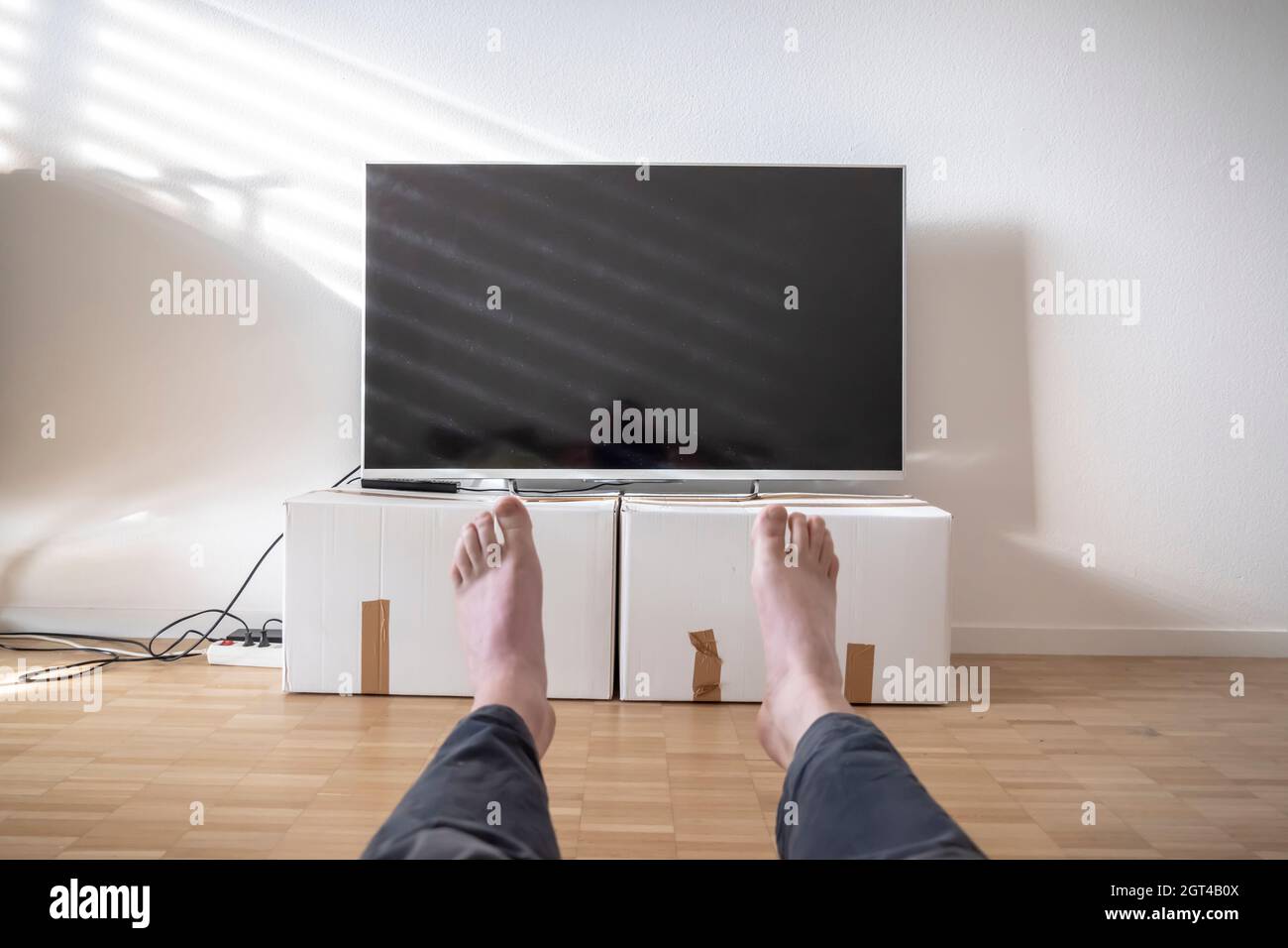 Television On Cardboard Box In Living Room And Men Legs In Switzerland  Stock Photo - Alamy