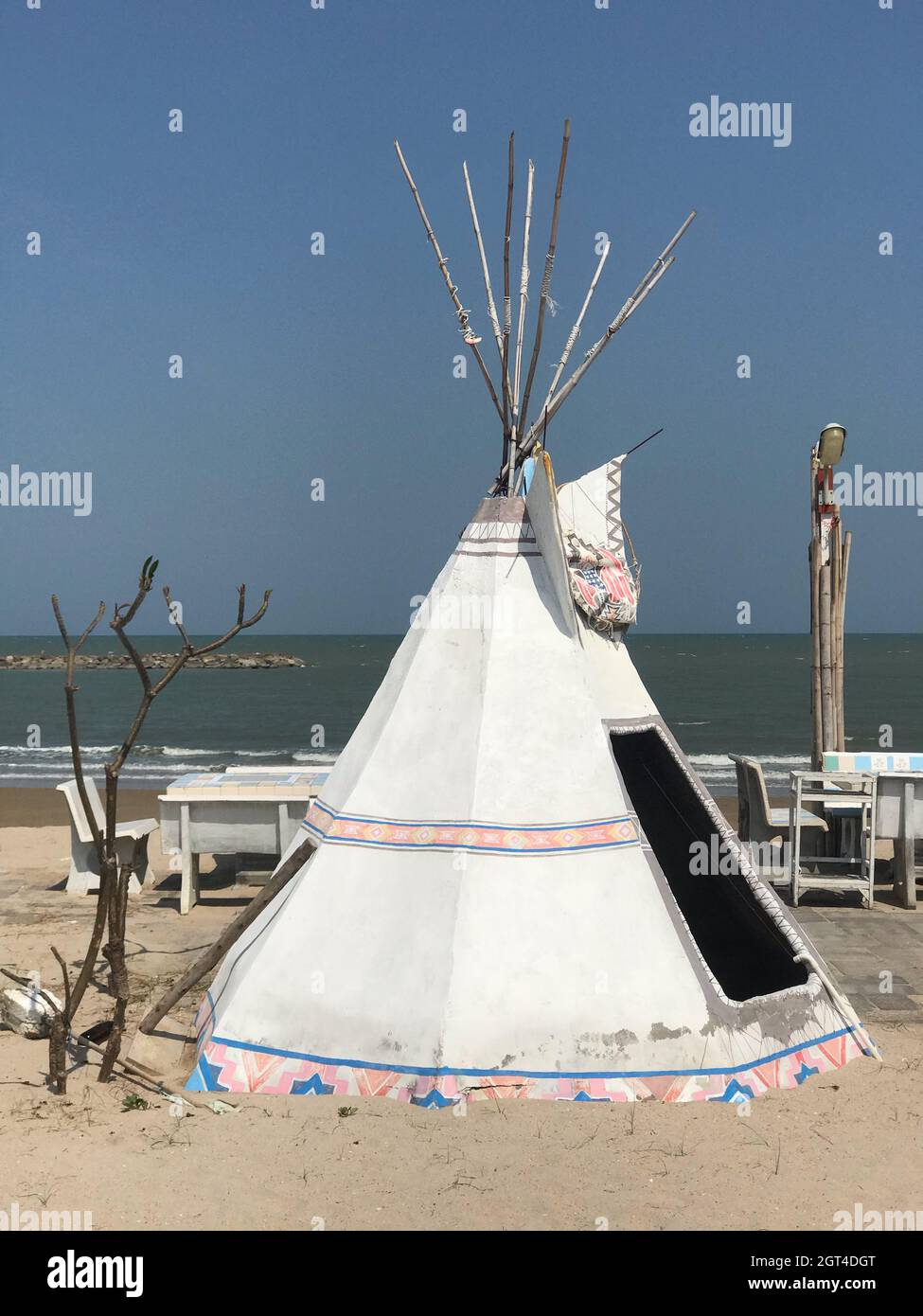 Traditional Windmill On Beach Against Clear Blue Sky Stock Photo