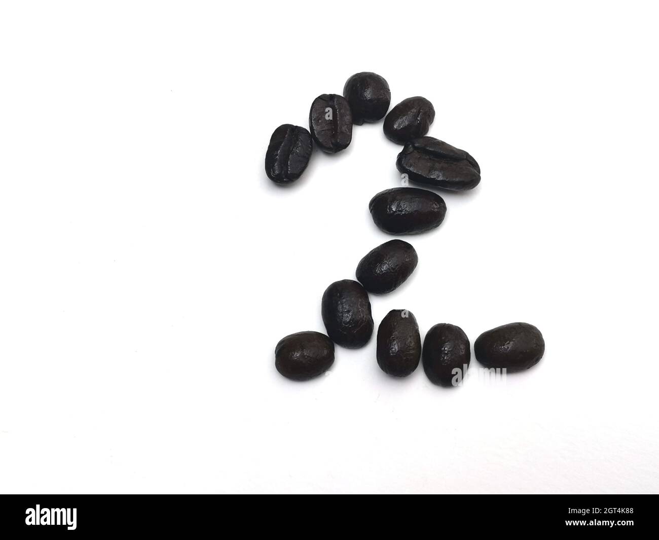 Close-up Of Coffee Beans Against White Background, Number 2. Stock Photo