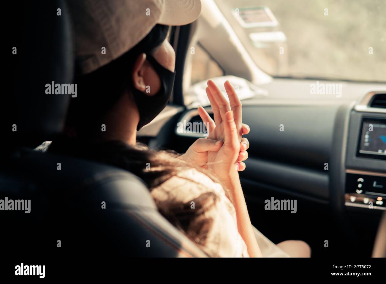 Rear View Of Woman Sitting In Car Stock Photo