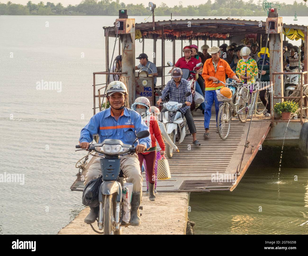 Passengers disembark from a small ferry in the Mekong River delta - Can ...