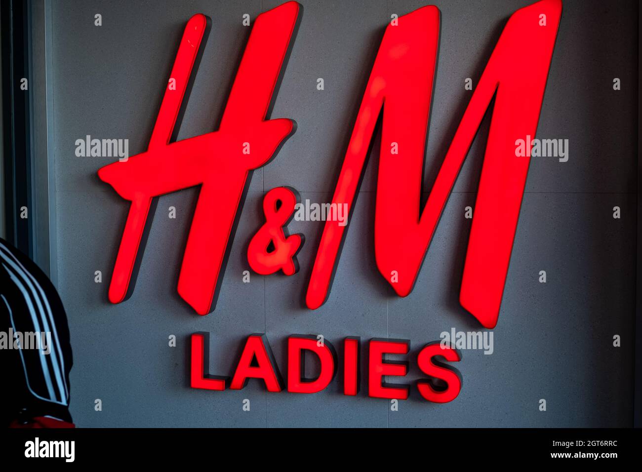 H&M logo is seen at the entrance of a H&M store in Beijing, China. 02-Oct-2021 Stock Photo
