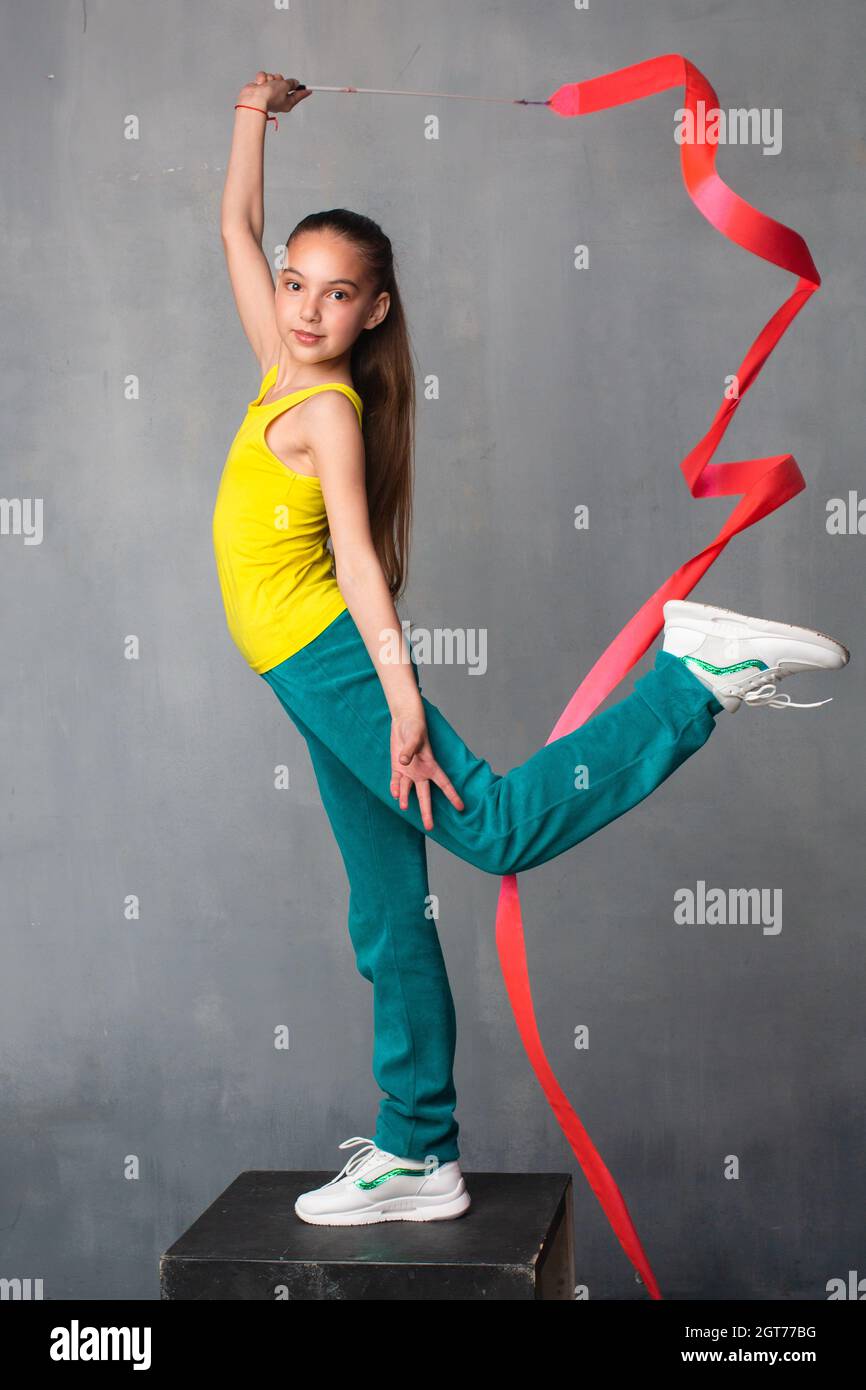 Gymnast With Ribbon. The Gymnast Raises Her Leg High. Good Stretch