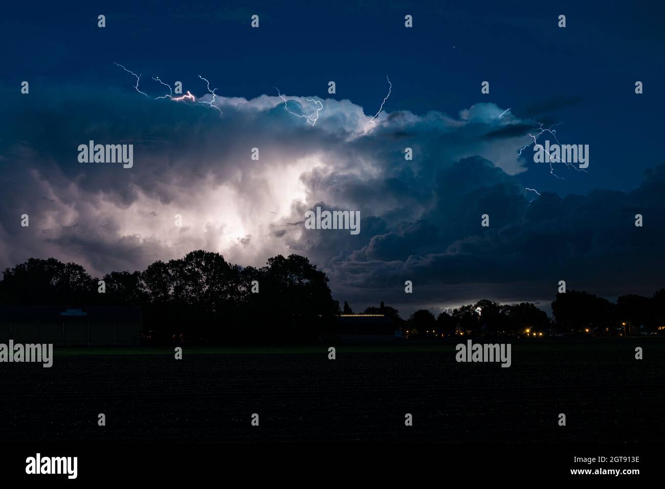 Upward Lightning from a Cumulonimbus thundercloud. From the anvil of a thunderstorm, lightning bolts shoot upwards into the stratosphere. Stock Photo