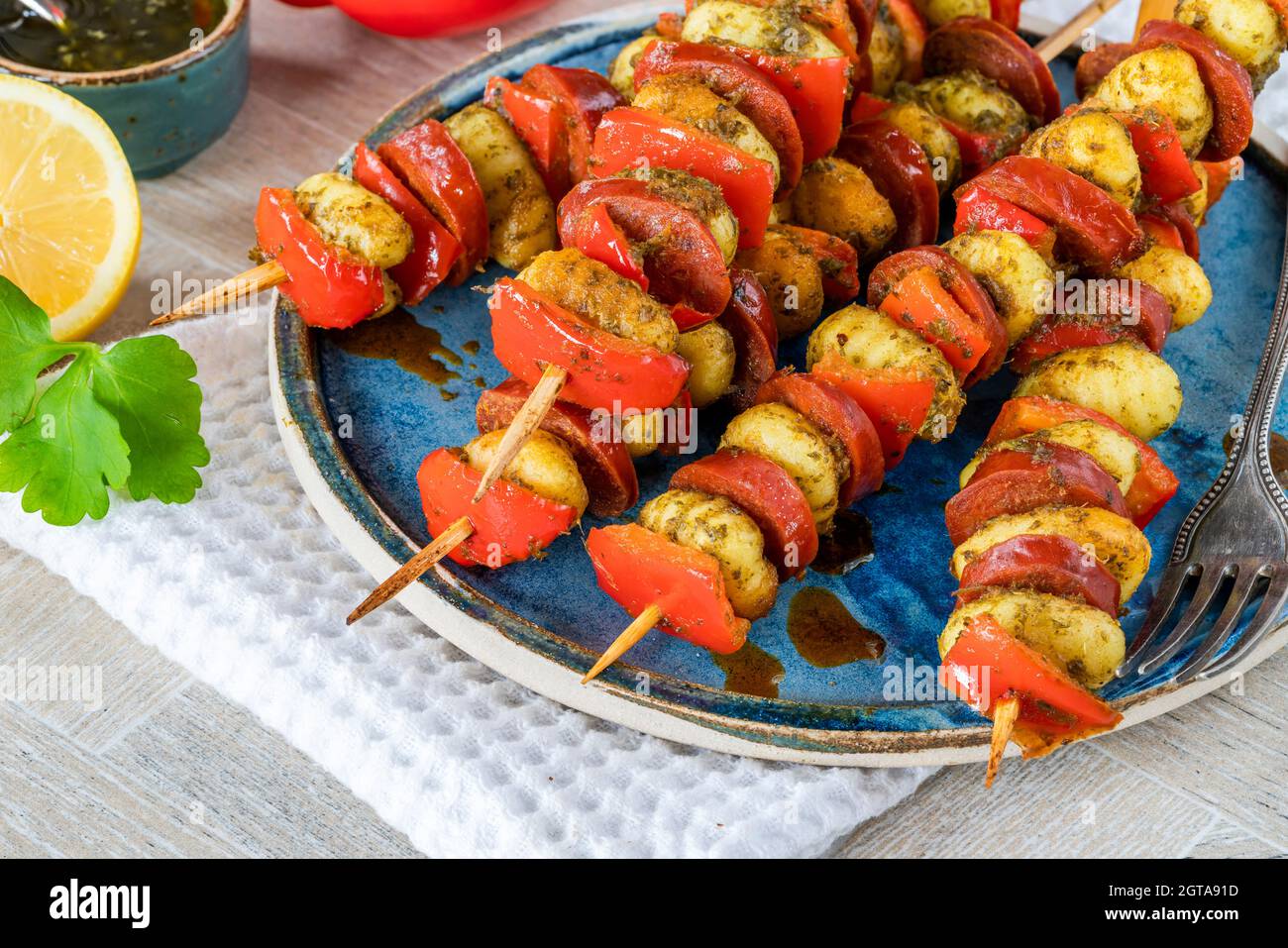 Crispy potato gnocchi skewers grilled with red peppers and chorizo Stock Photo Alamy