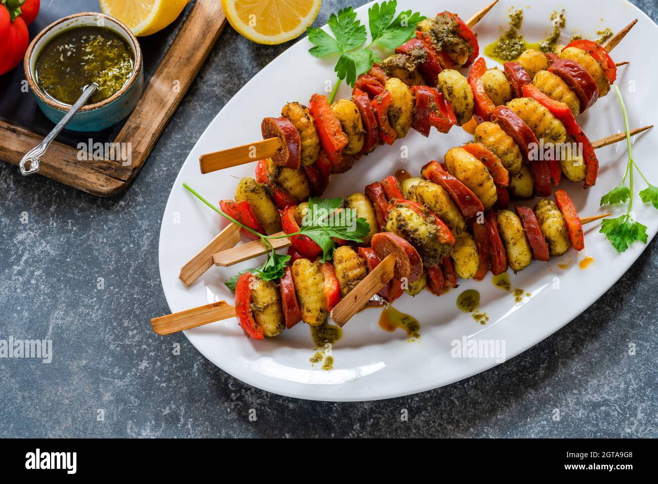 Crispy potato gnocchi skewers grilled with red peppers and chorizo Stock Photo Alamy