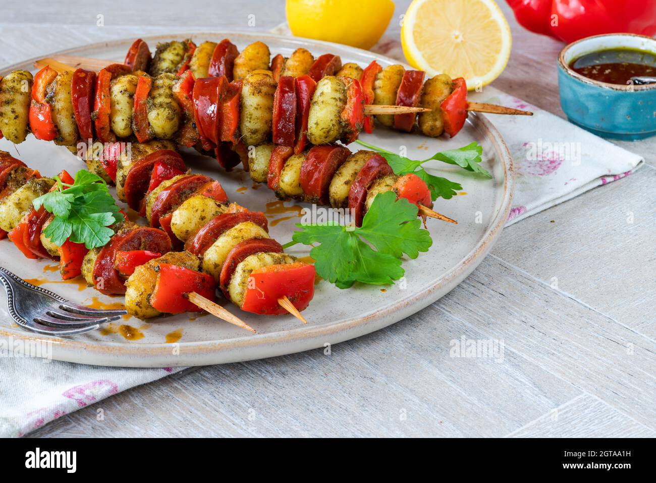 Crispy potato gnocchi skewers grilled with red peppers and chorizo Stock Photo Alamy