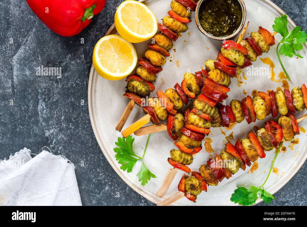 Crispy potato gnocchi skewers grilled with red peppers and chorizo