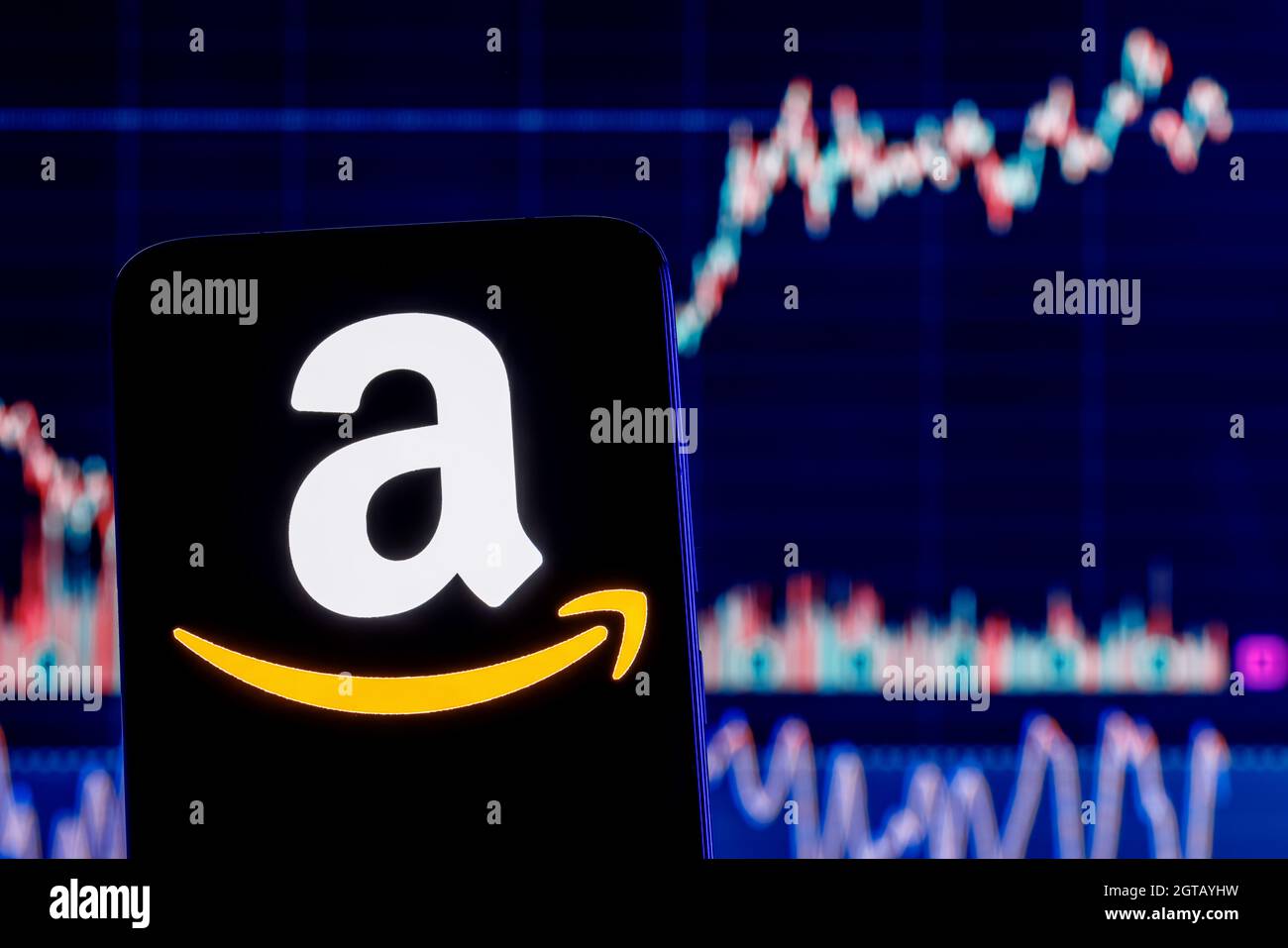 Smartphone with Amazon logo on the background of the stock chart. Stock Photo