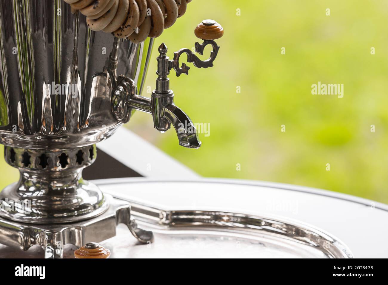 Faucet of traditional Russian Samovar, a metal container used to heat and boil water for tea ceremony Stock Photo