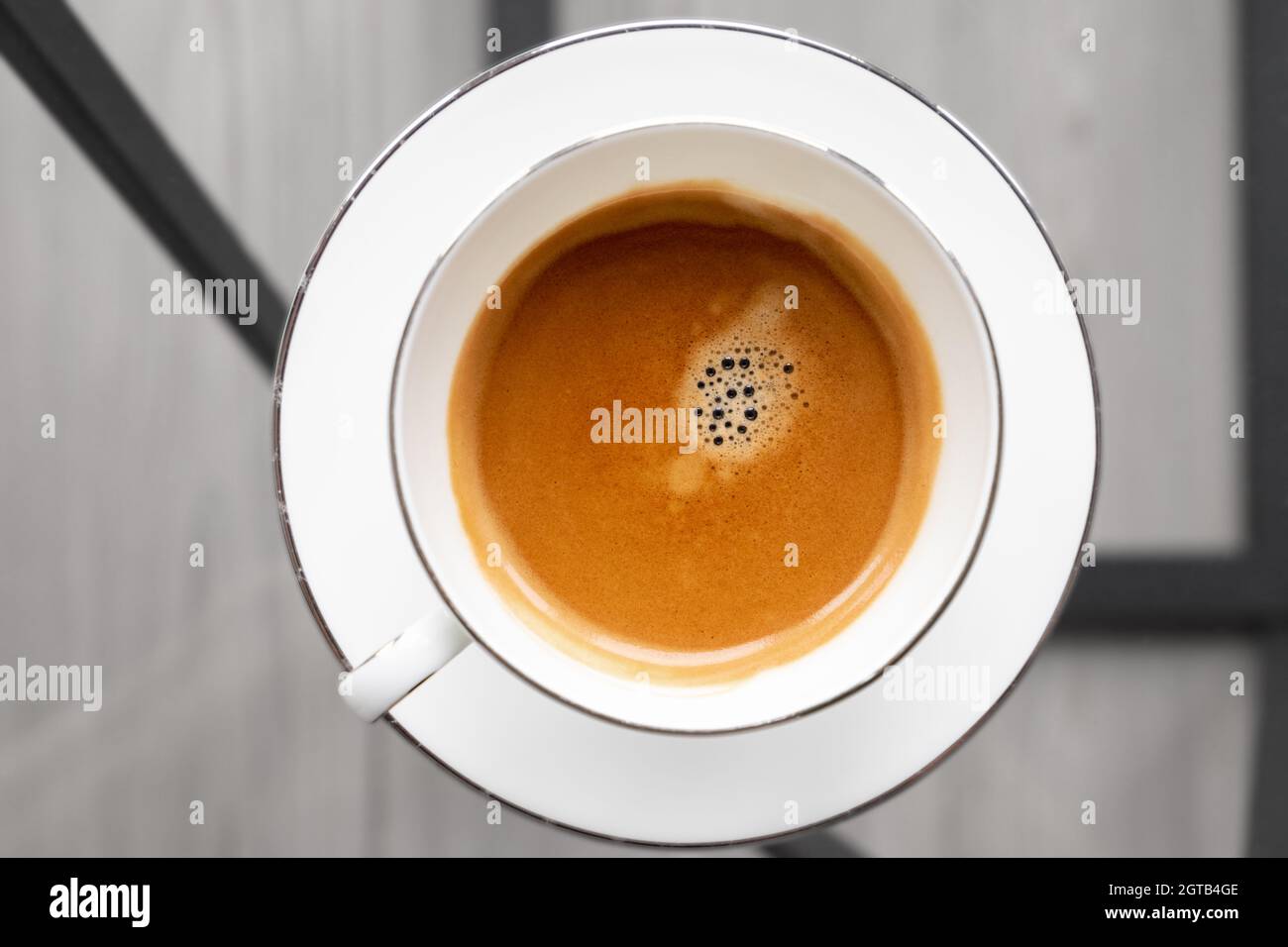 https://c8.alamy.com/comp/2GTB4GE/espresso-coffee-in-a-white-cup-stands-on-saucer-top-view-closeup-photo-with-selective-focus-2GTB4GE.jpg