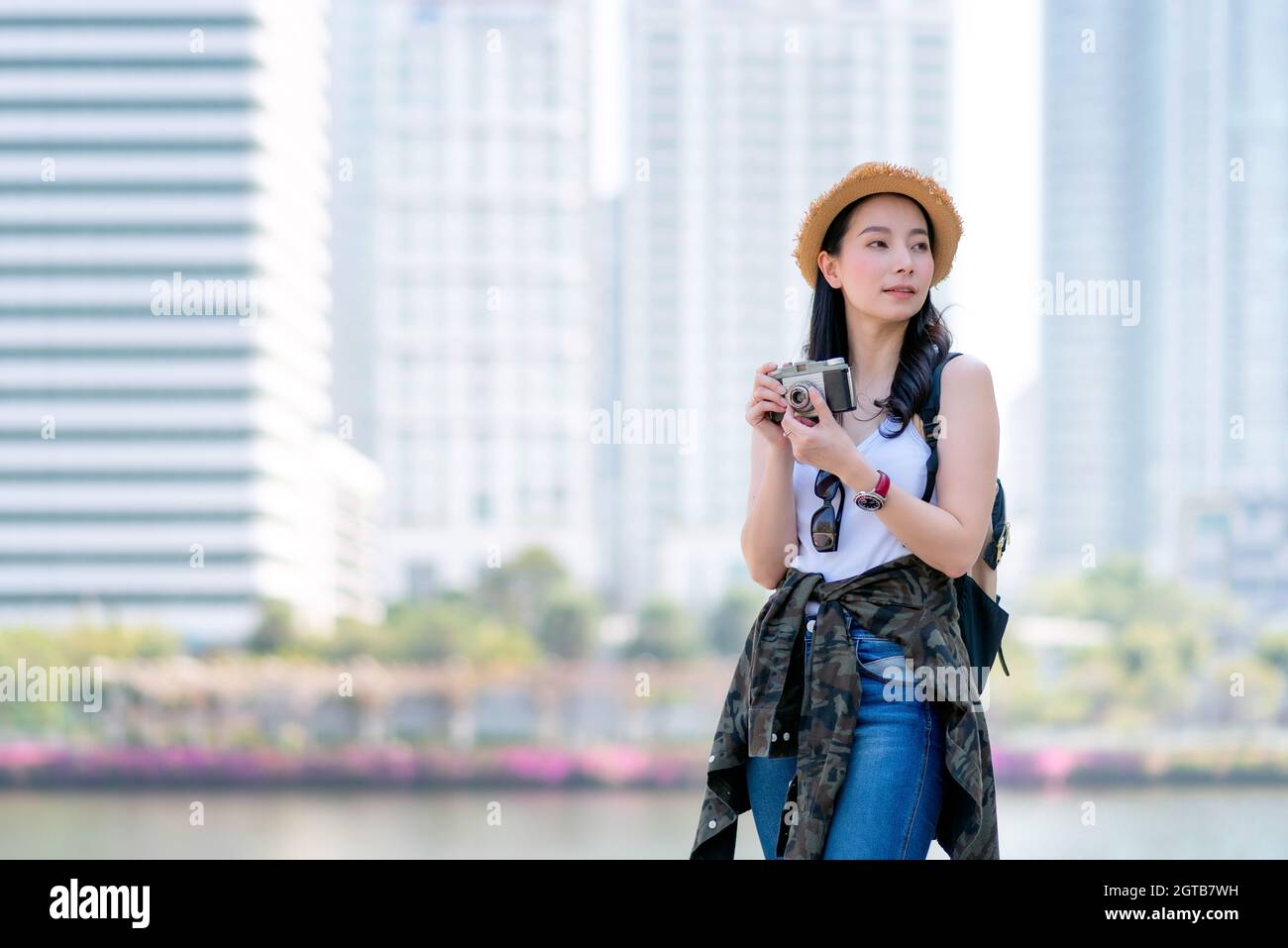 Beautiful Asian Tourist Woman Enjoy Taking Photo By Retro Camera At Tourist Sightseeing Spot Stock Photo