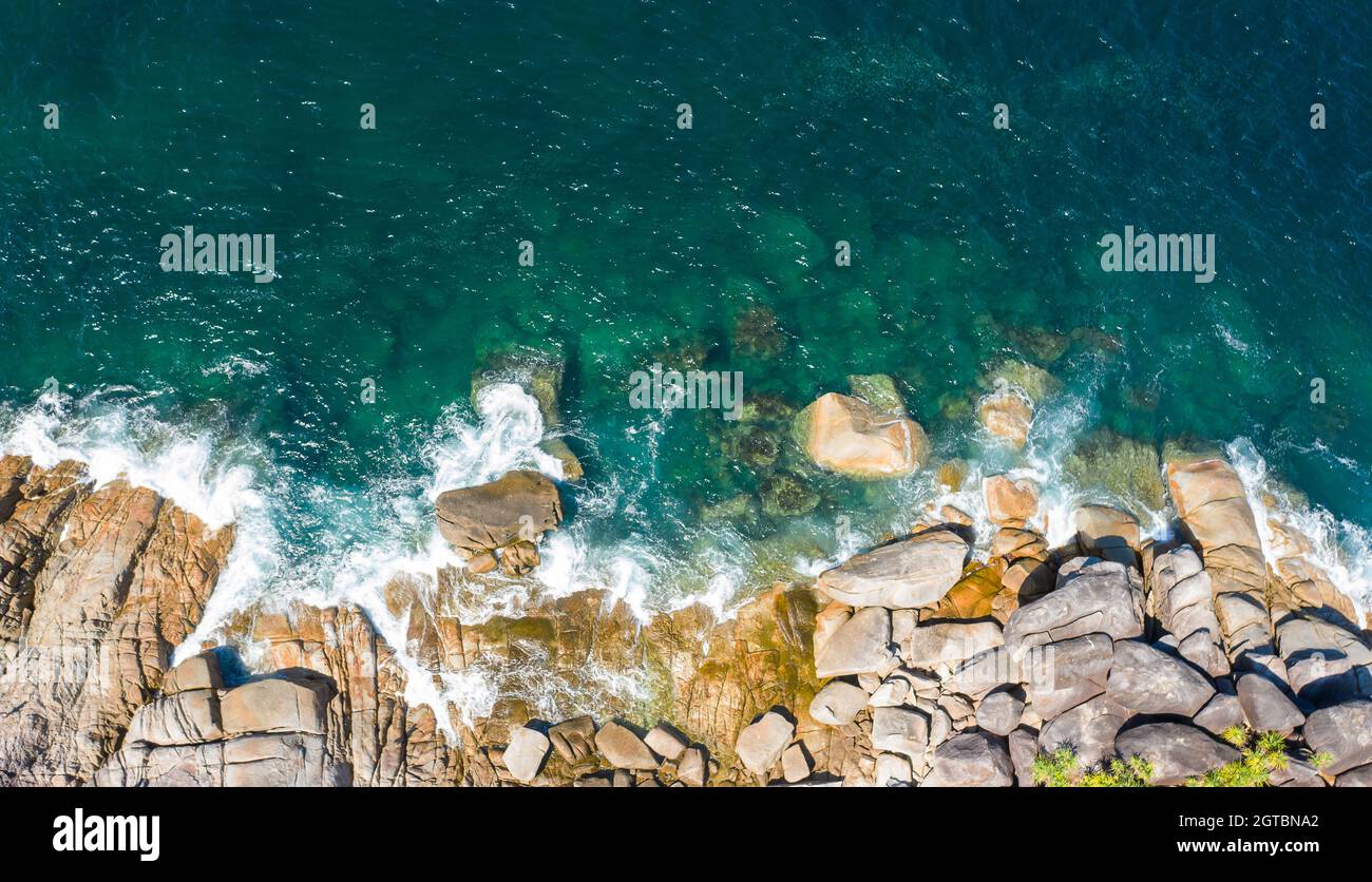 High Angle View Of Waves Splashing On Rocks Stock Photo