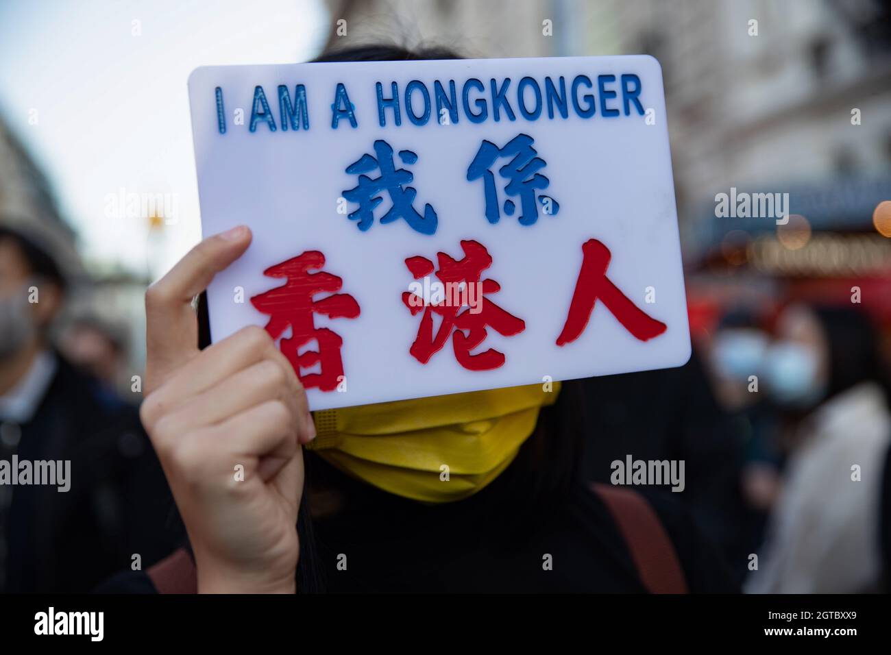 London, UK. 01st Oct, 2021. A demonstrator holds a sign reading 'I am a HongKonger' during the protest against Chinese Communist Party repression on Hong Kong, Tibet, and Xinjiang on China's National Day outside the Chinese Embassy in London.Hongkongers, Tibetans, and Uyghurs communities held a joint rally and march in London to protest against the celebration of the 72th anniversary of the National Day of the People's Republic of China. The rally started on Piccadilly Circus and called the public to join the petition to boycott the Winter Olympics which is going to be held in Beijing next yea Stock Photo