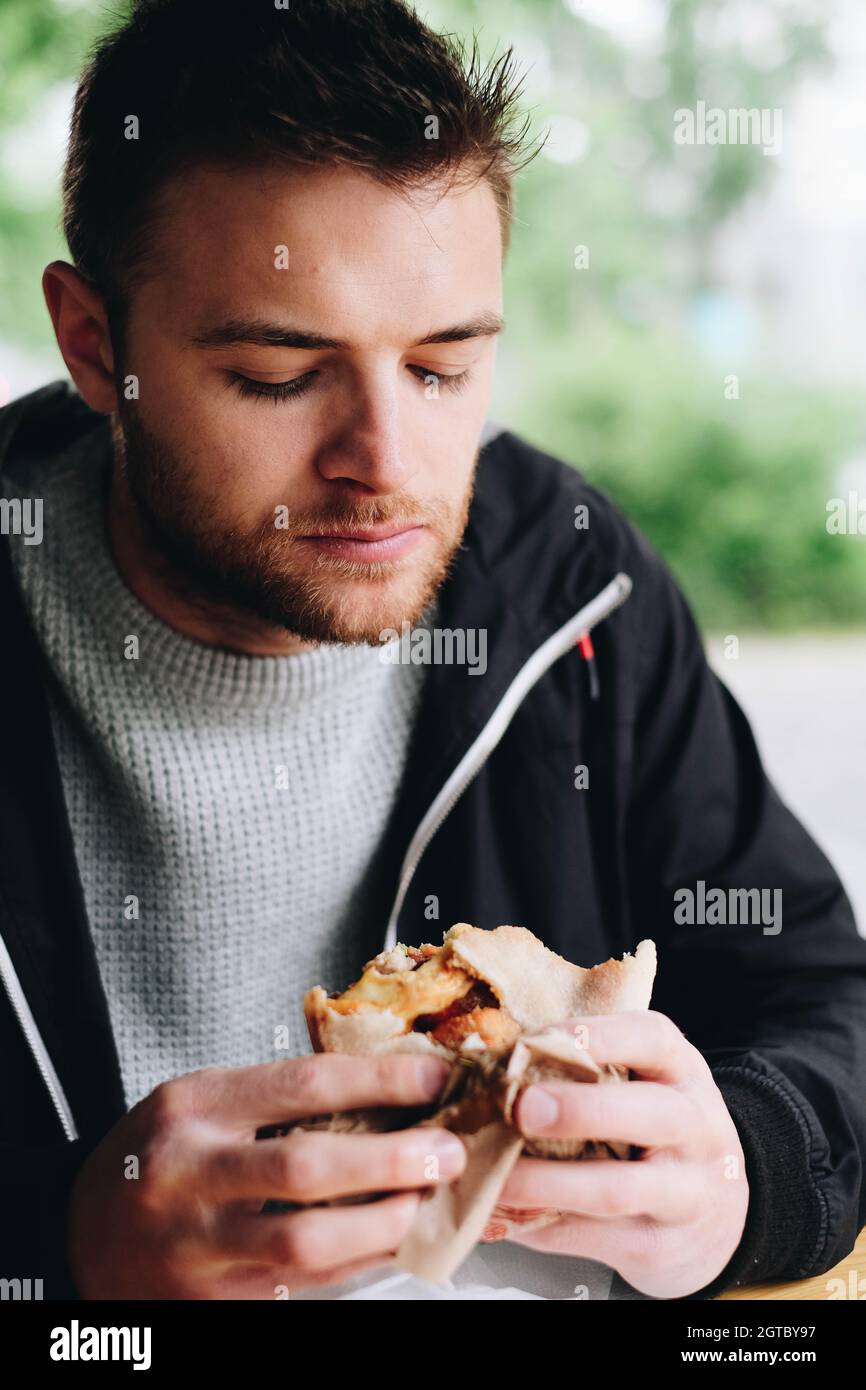 Man Eating Food At Window Stock Photo Alamy
