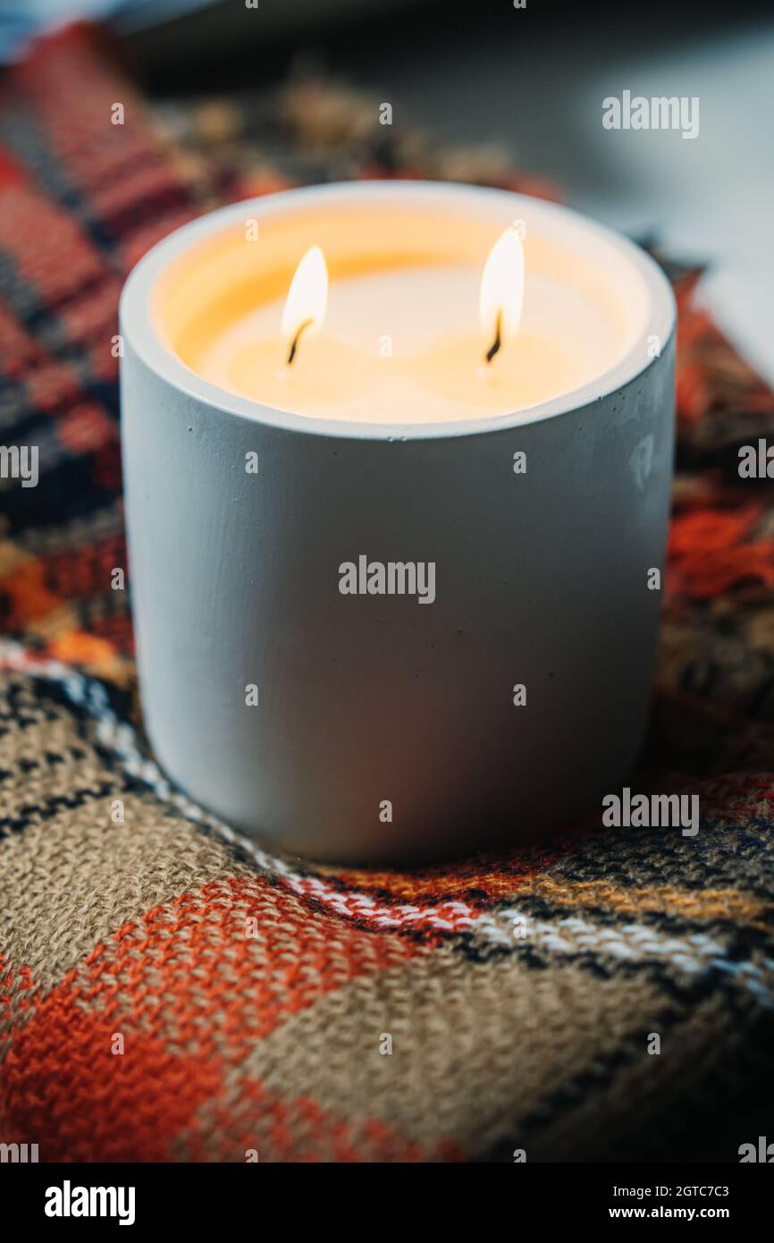 Burning candle with two wicks, handmade candle in white jar Stock Photo ...