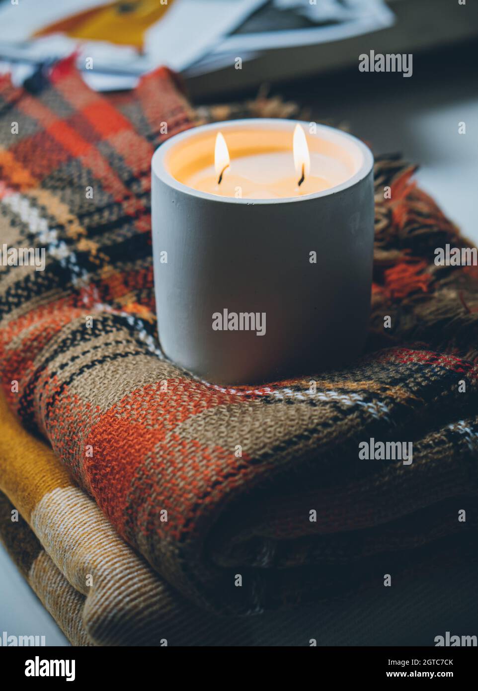 Burning candle with two wicks, handmade candle in white jar Stock Photo