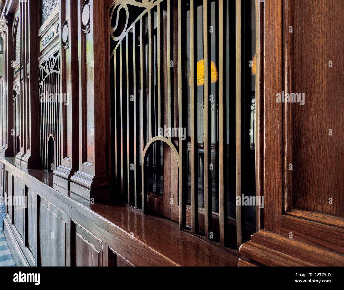 Wooden facade of a building with windows covered by railings Stock ...