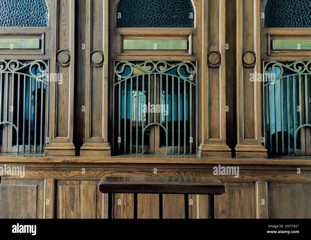 Wooden facade of a building with windows covered by railings Stock ...