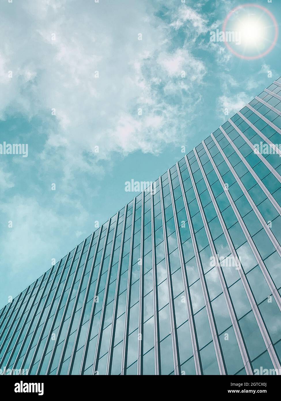 Tall office building in blue sky background Stock Photo - Alamy