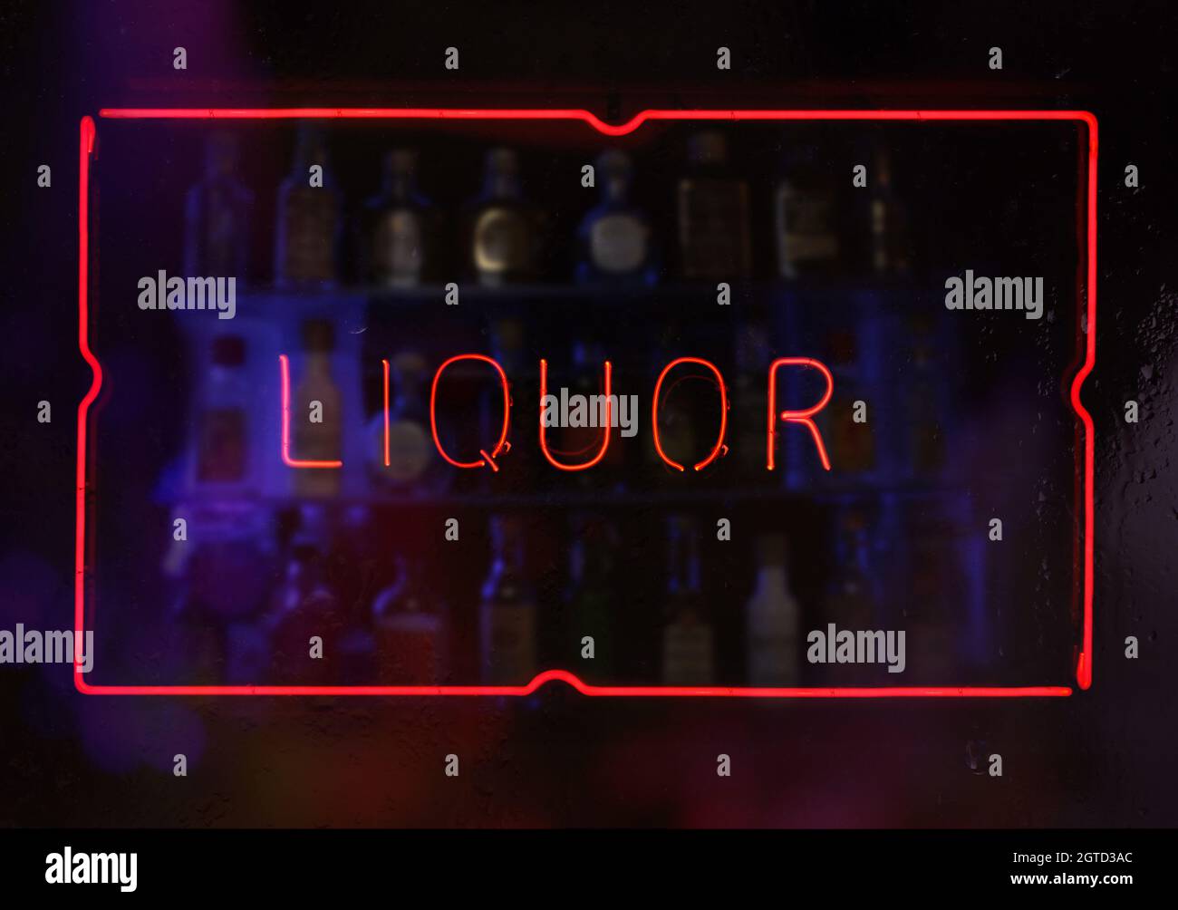 Neon Liquor Sign in Wet Window Stock Photo Alamy