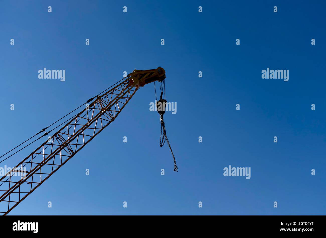 Part of the construction of a crane with a hook for lifting weights against a blue sky, suitable for placing text or image, Sofia, Bulgaria Stock Photo
