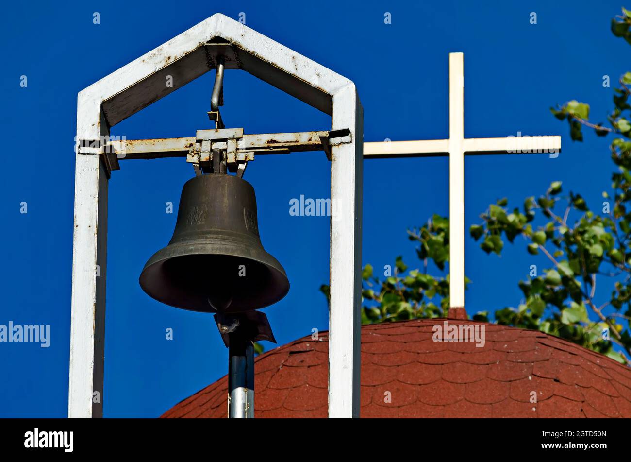 Bell and cross on the roof of a church symbol of Orthodox Christianity, residential district Drujba, Sofia, Bulgaria Stock Photo