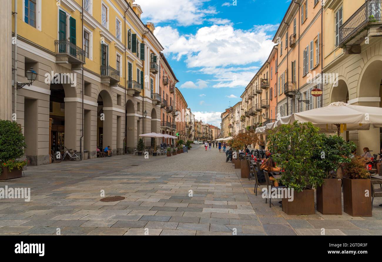 Cuneo, Piedmont, Italy - August 2, 2021: Via Roma with historic colorful buildings with arcades (portici of Cuneo), central pedestrian main street. Stock Photo
